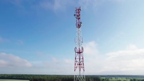 Aerial View of a Mobile Communication Tower Against the Background of Floating Clouds