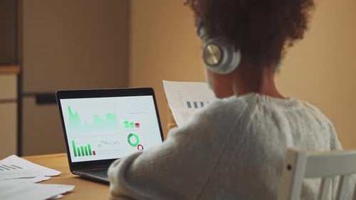 African Girl is Learning to Work with Financial Statistics on a Remote Work at Home Working with