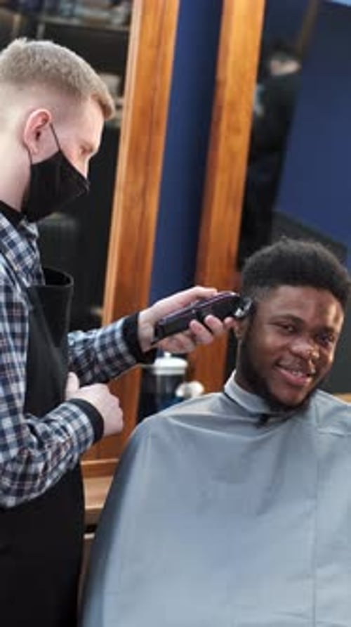Young Africanamerican Man Visiting Barbershop for Haircut