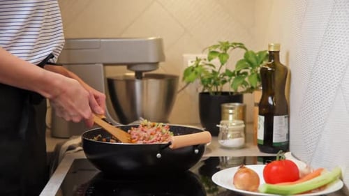 Woman Cooking Sauce Bolognese in Kitchen