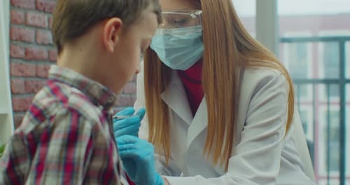 Child Receiving Injection from Doctor at Medical Exam