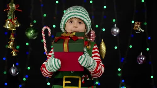 Girl Elf Holds Christmas Presents in Festive Setting