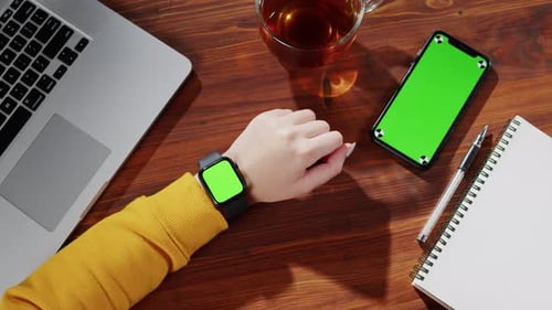 Businesswoman Using Smartwatch with Green Screen Top View