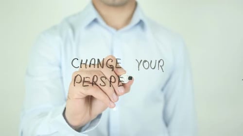Man Writes "Change Your Perspective" On Glass