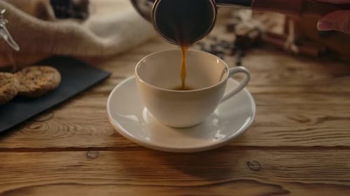 Coffee Pouring Into Cup with Cookies Close Up