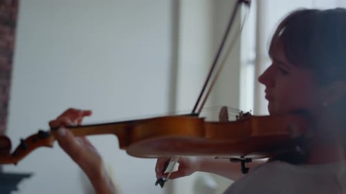 Woman Plays Violin in a Bright Room