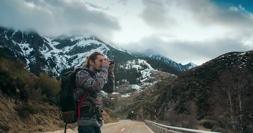 Lifestyle Photographer Making Content on Mountain Journey Using Vintage Camera