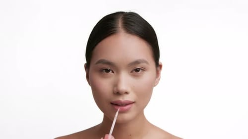 Korean Lady Applying Lipstick Smiling Making Makeup Over White Background