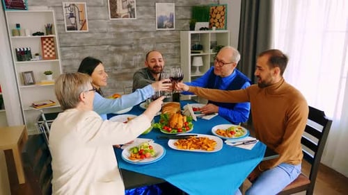Top View of Family Clinking Glasses with Red Wine