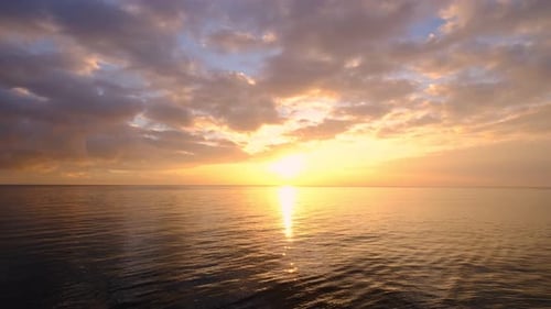 Golden Sunset Reflecting over Calm Ocean Waters