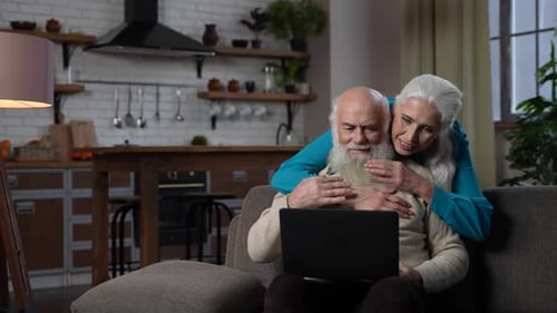Loving Aged Couple Using Laptop for Video Call
