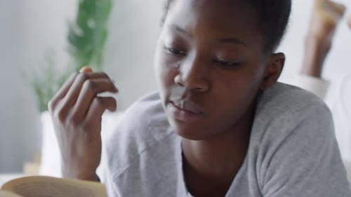 Young Adult Reading and Relaxing in Bed