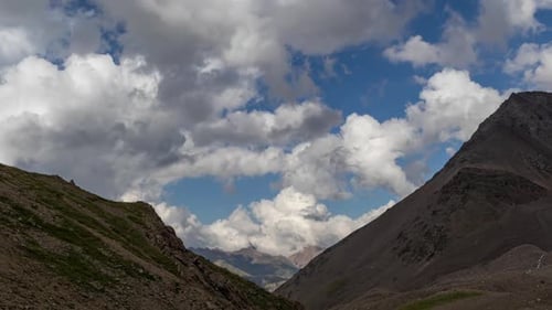 Puffy clouds over the mountains.