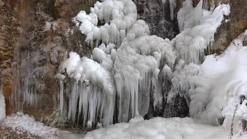 Icy Cliffside with Thick Icicles in Winter