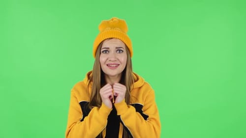 Portrait of Modern Girl Is Looking at Camera with Excitement, Then Celebrating Victory. Green Screen