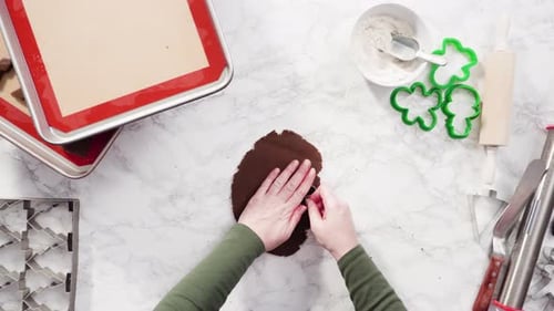 Flat lay. Step by step. Cutting out shapes with Christmas cookies cutter from gingerbread cookie dou
