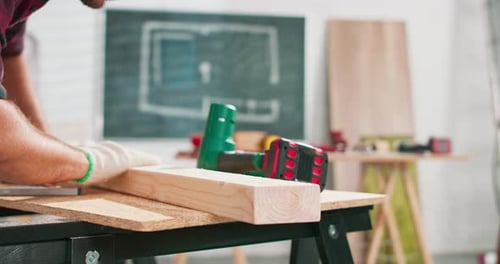 Carpenter Working with Wood Plank in Workshop