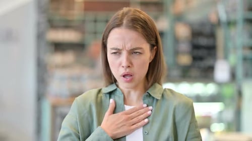 Young Woman Coughing due to Illness, Health Condition