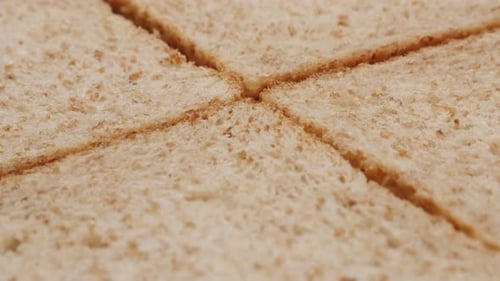 Lot of whole grain toast bread pieces close-up tilting 4K 2160p 30fps UltraHD footage - Toasting b