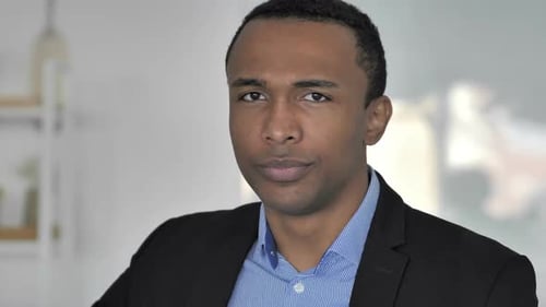 Thumbs Down By Casual AfroAmerican Businessman Looking at Camera
