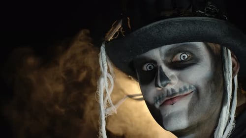 Adult in Skull Makeup and Hat on Dark Background