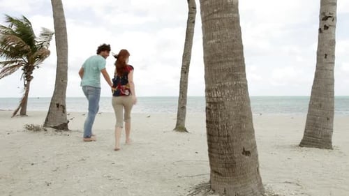 Young couple running on beach