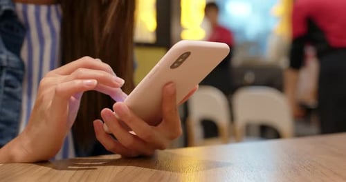 Woman use of smart phone in coffee shop