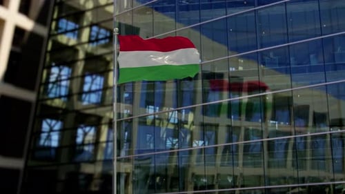 Realistic Hungarian Flag Waving in Front of Modern Glass Building