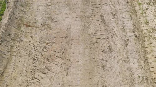 Aerial top view of dry ground rough cracks in the land with sand in paddy rice field.