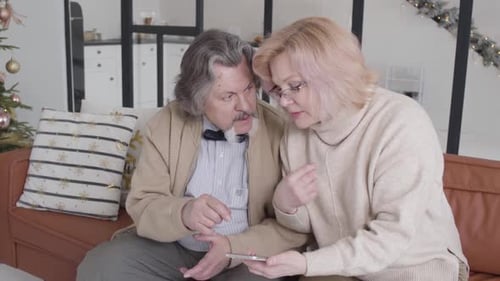 Mature Couple Looking at Smartphone Together