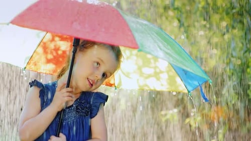 Funny Girl Hiding Under an Umbrella From the Rain. Warm Summer Rain