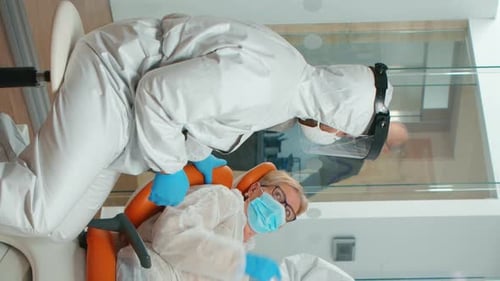 Healthcare Worker Tending to Patient in Hospital Chair