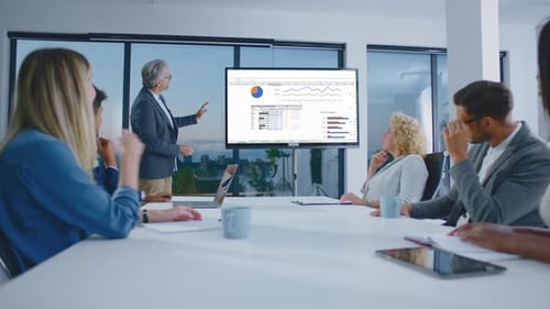 Professionals Meeting Around Conference Table for Presentation