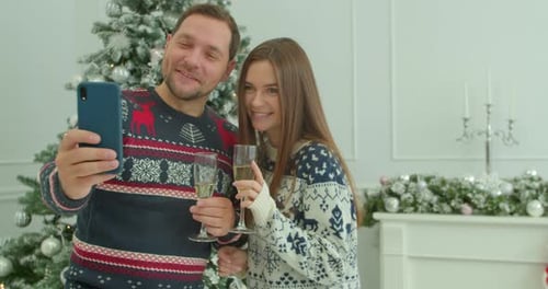 Smiling Couple Celebrates Christmas and Takes a Selfie