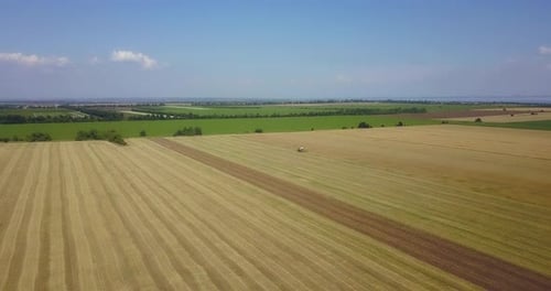 Tractor Plowing Field from Aerial View