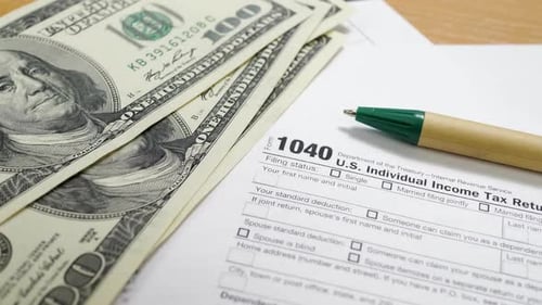 IRS Tax Form with One Hundred Dollar Bills