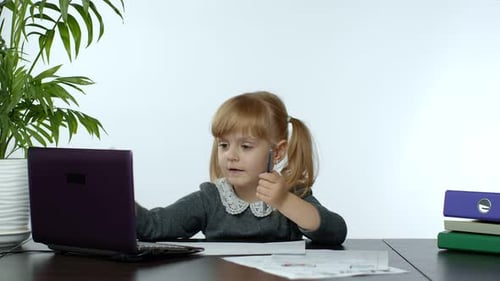 Young Child Learning at Desk with Laptop