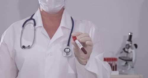 Medical Professional Holding COVID-19 Blood Test in Lab