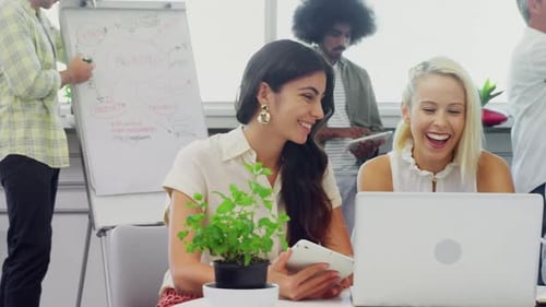 Smiling Colleagues Brainstorming Together in Modern Office