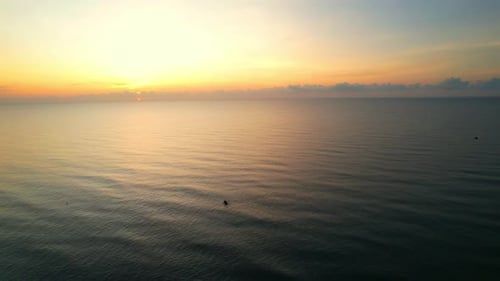 4K drone flying over the sea, sunset on the horizon