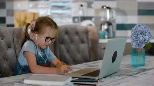 Young Girl Engaged in Online Learning at Home