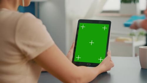 Freelancer Woman Holding Tablet Computer with Mock Up Green Screen