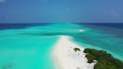 Wide angle aerial travel shot of a sandy white paradise beach and aqua turquoise water background in