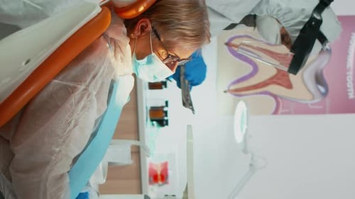 Dentist Examining Patient Teeth in Medical Office