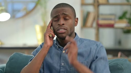 Young Adult Massaging Temples Indoors