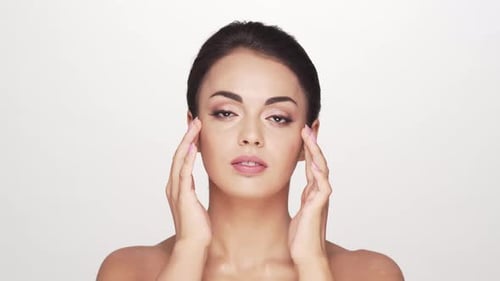 Studio portrait of young and beautiful brunette woman over
