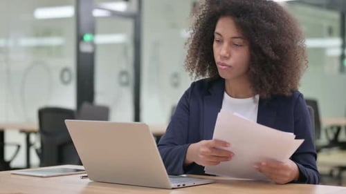 Woman Working on Laptop in Modern Office