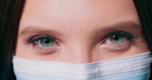 Young Adult in Surgical Mask, Close Up