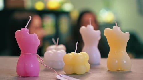 Hand made colored candles with two women on the background