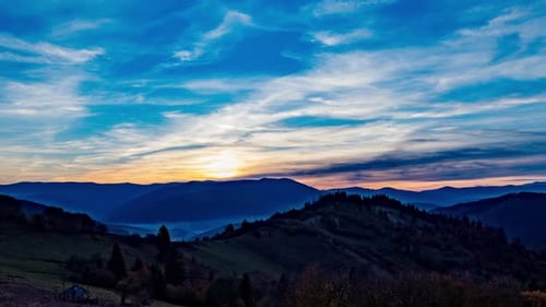 Majestic Sunrise Over Rolling Mountain Landscape